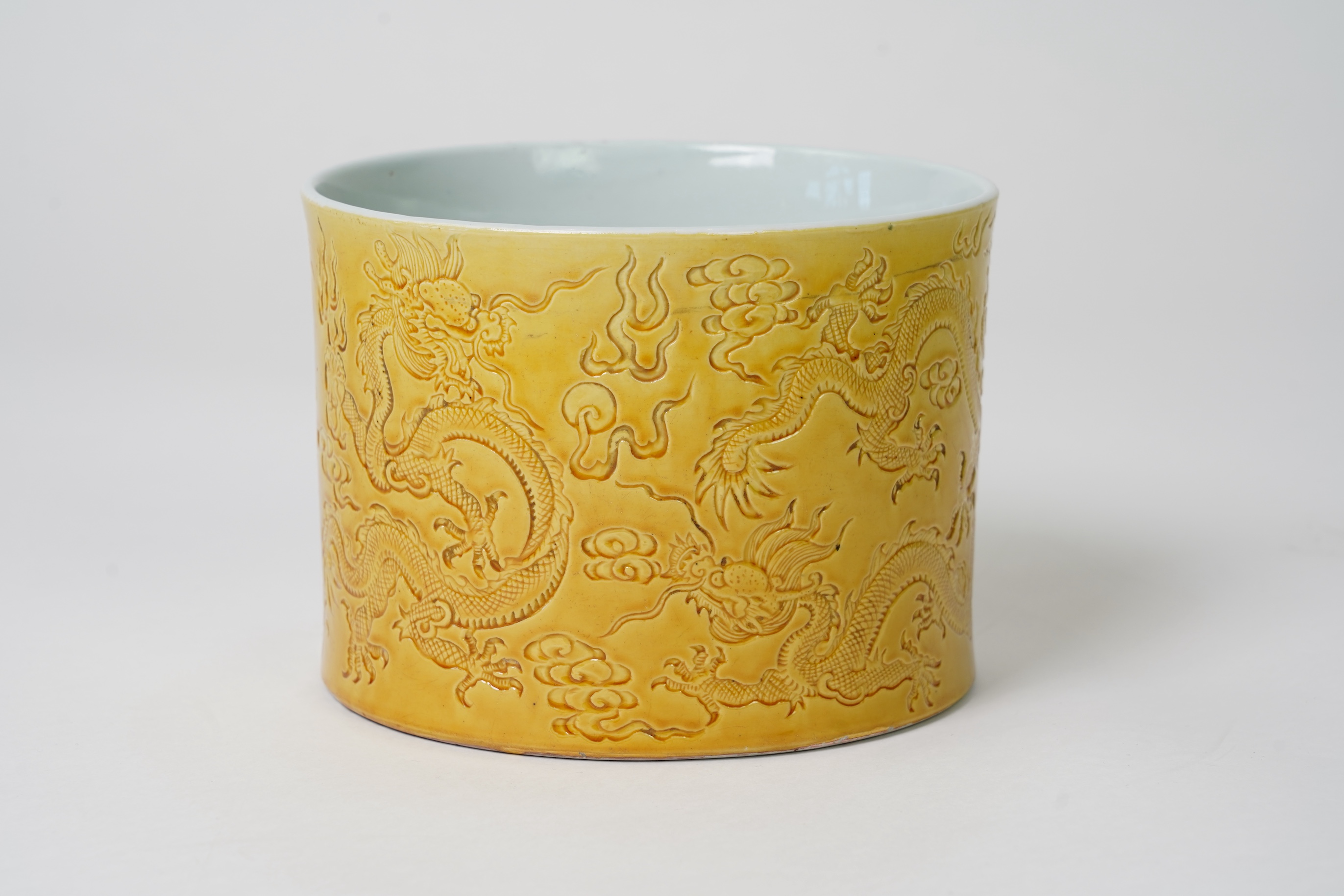 A Chinese yellow glazed 'dragon' brush pot, possibly Republic period